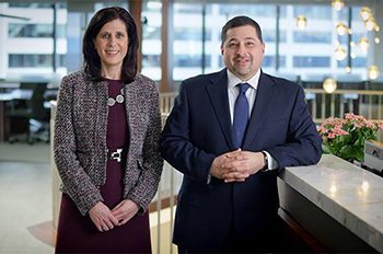two people standing at front desk